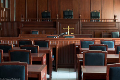 A table and chair in the courtroom of the judiciary.